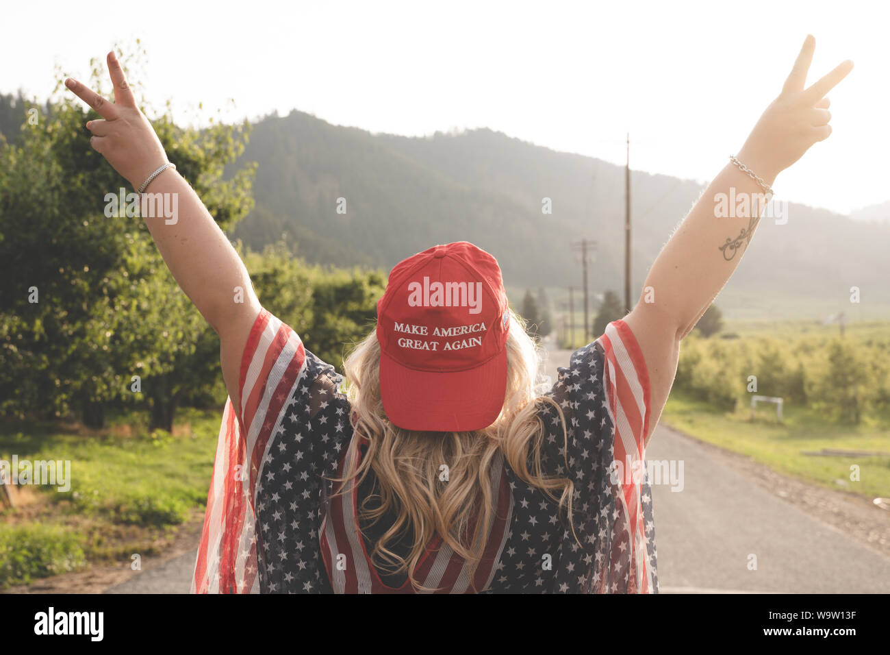 Wenatchee, Washington - July 4, 2019: Republican woman wearing a MAGA hat (Make America Great Again) supporting President Donald Trump and his 2020 re Stock Photo