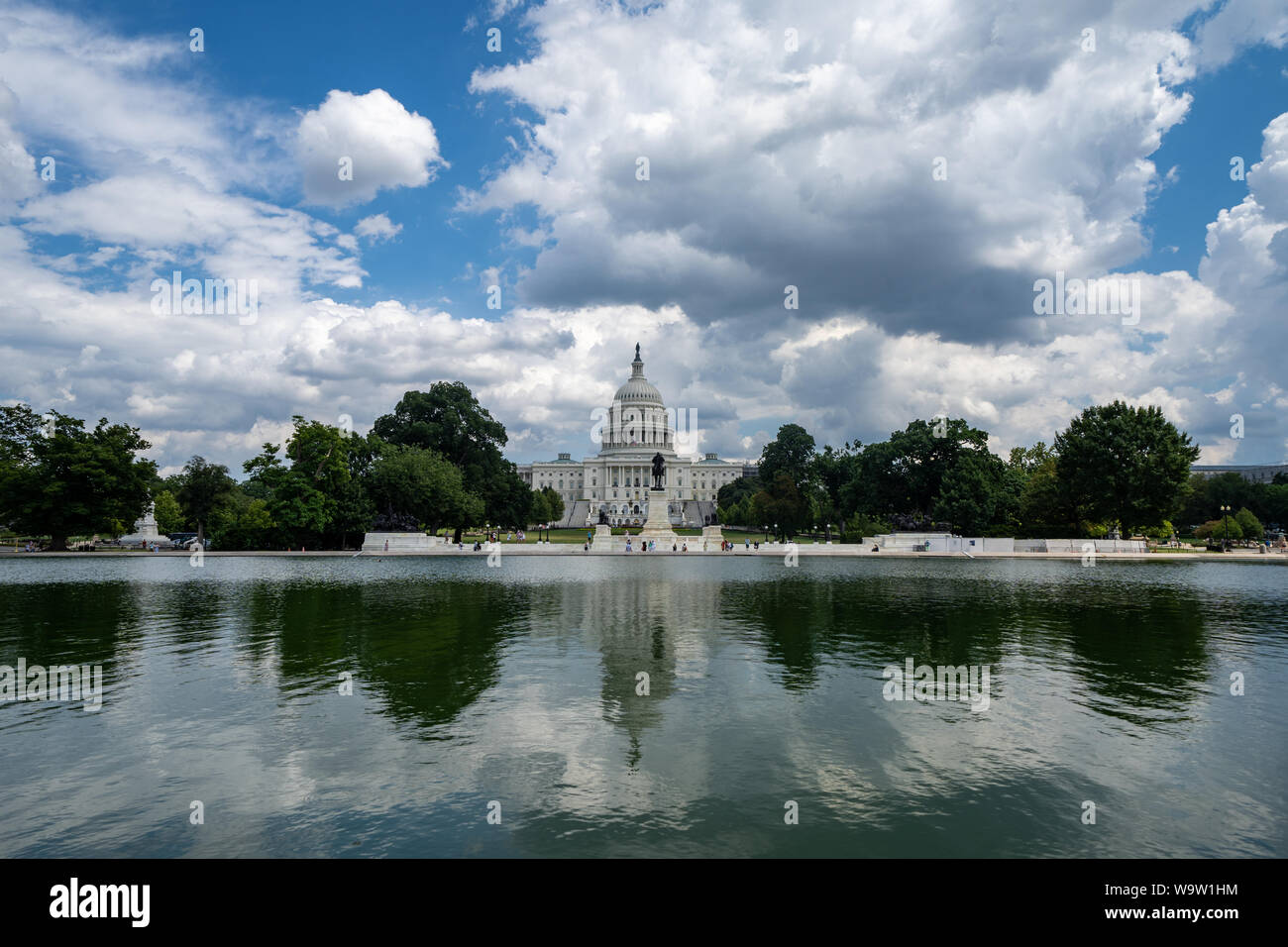 Wide angle view of the United States Capitol Building in Washington DC on a partly cloudy summer day, on the reflecting pool Stock Photo