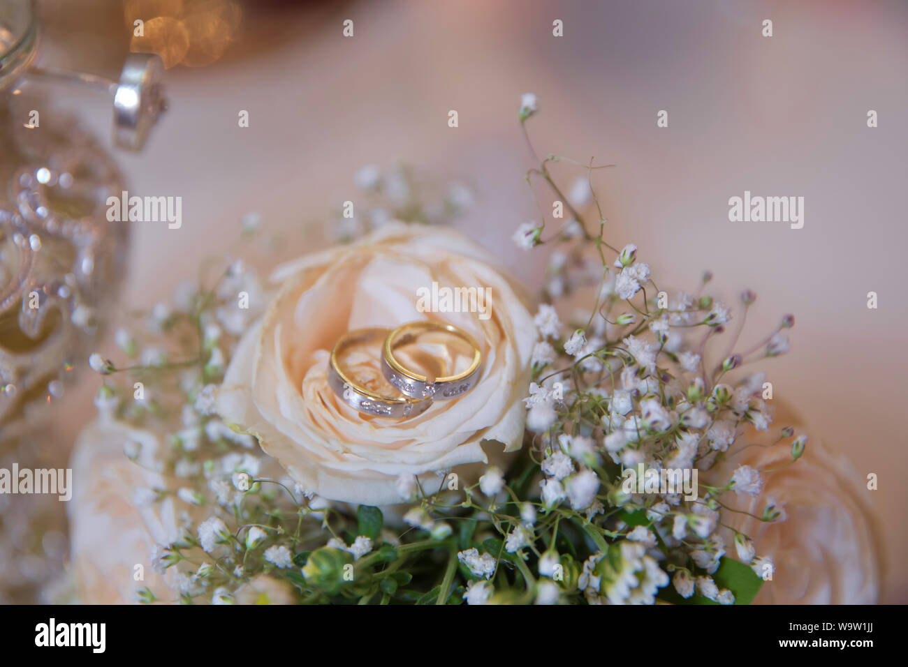 Stylish white wedding flower . Rings on wedding bouquets Stock Photo