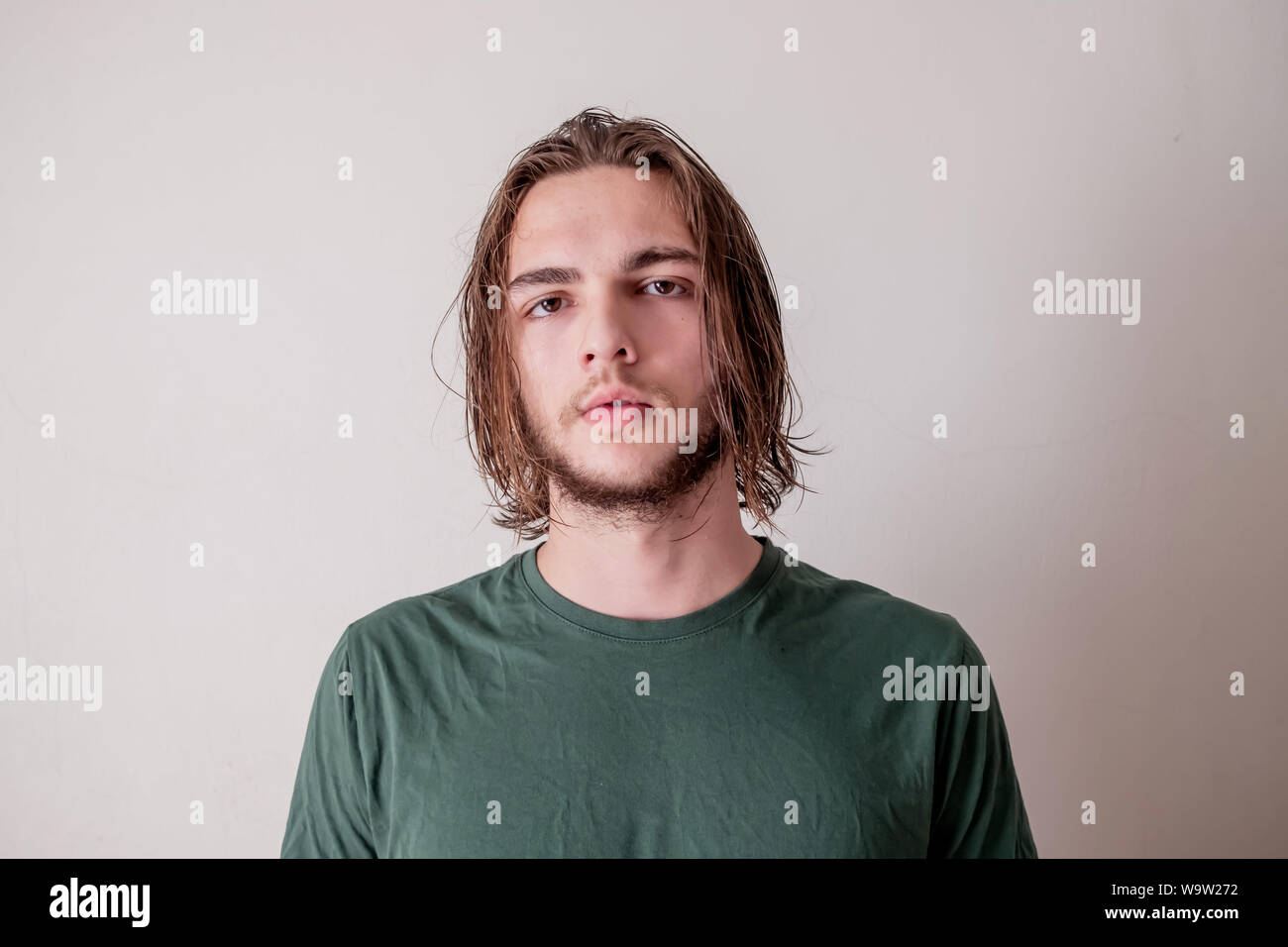 Boy or young man look at the camera with wet hair and beard, portrait of wet  hair boy Stock Photo - Alamy