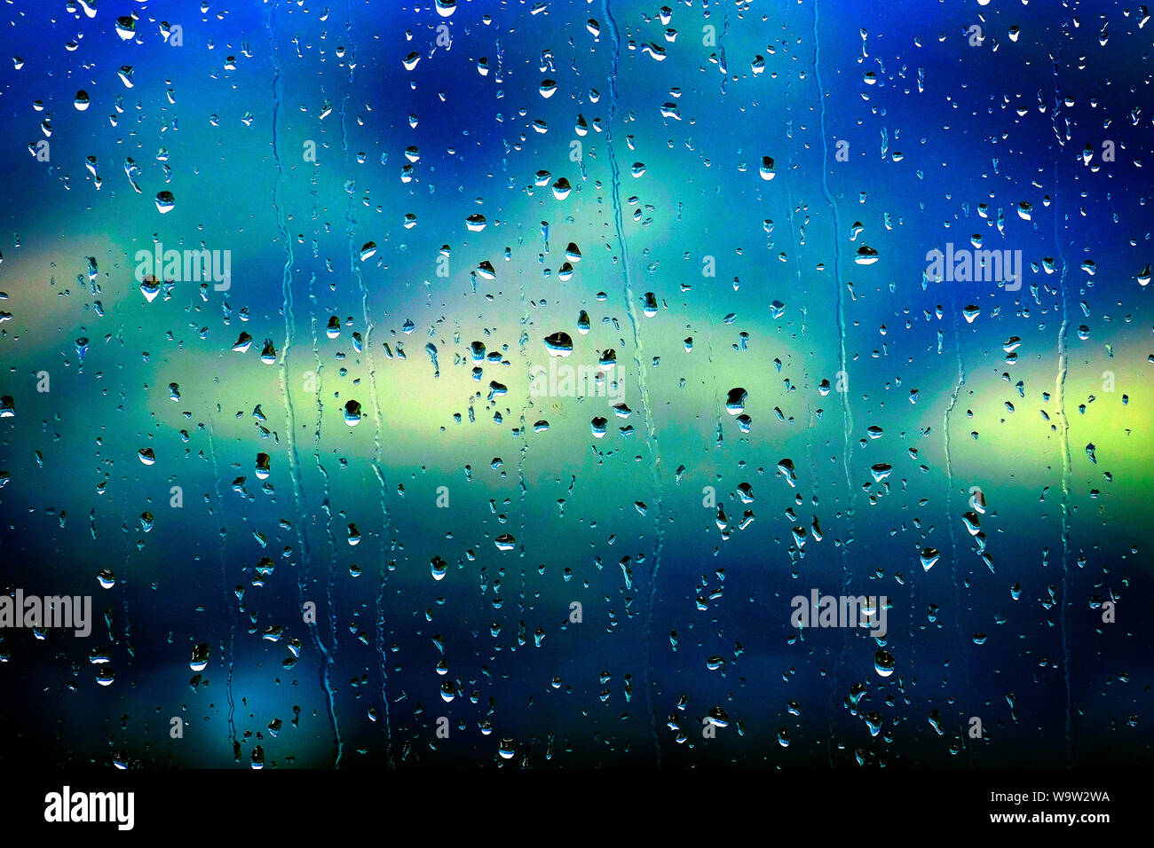 Rain drops drips water wet on window glass Stock Photo - Alamy