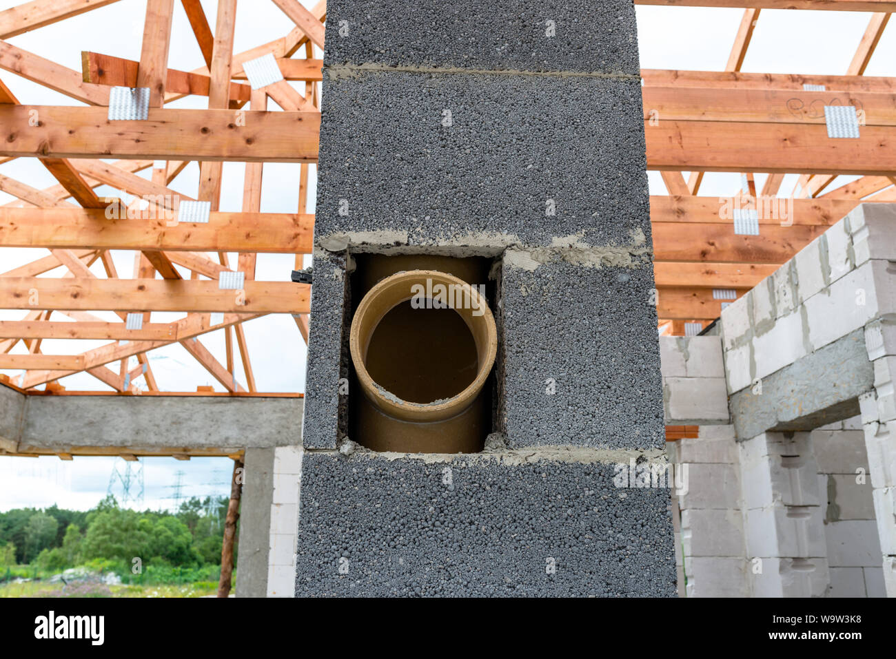 System chimney on a detached house under construction, visible chimney block and elements of