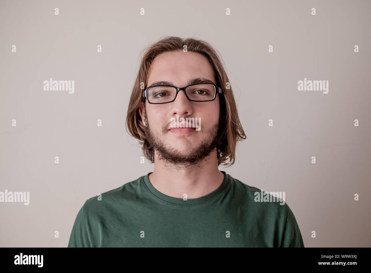 Young college student guy looking at camera, portrait of smiling young boy with eyeglasses Stock Photo