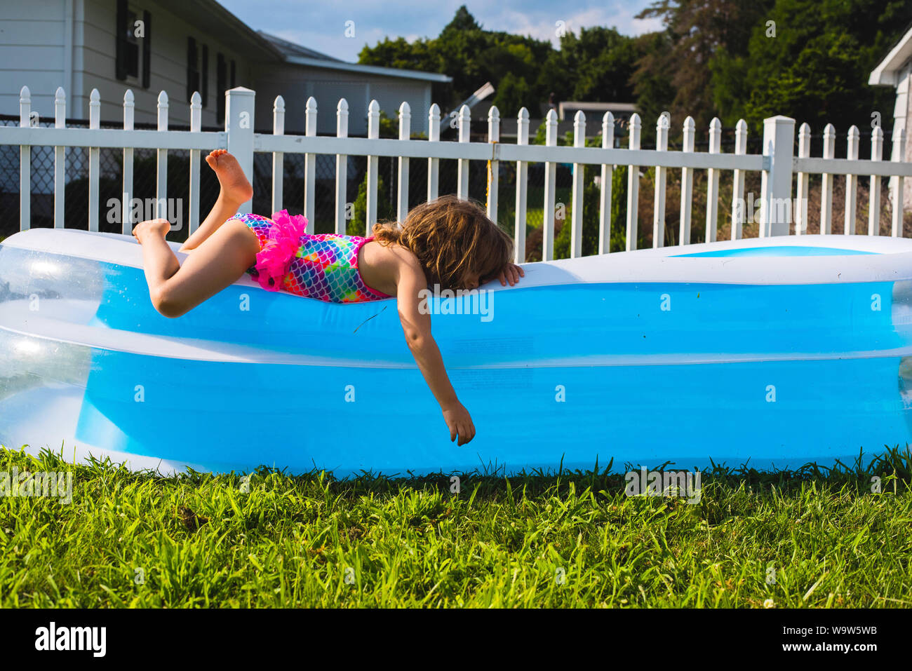 Person laying by the pool hires stock photography and images Alamy