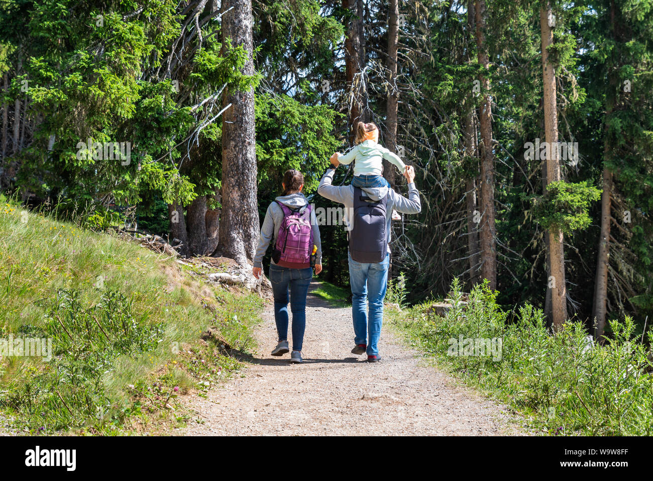 Family Walking Hiking Trail In Mountains In Summer Stock Photo