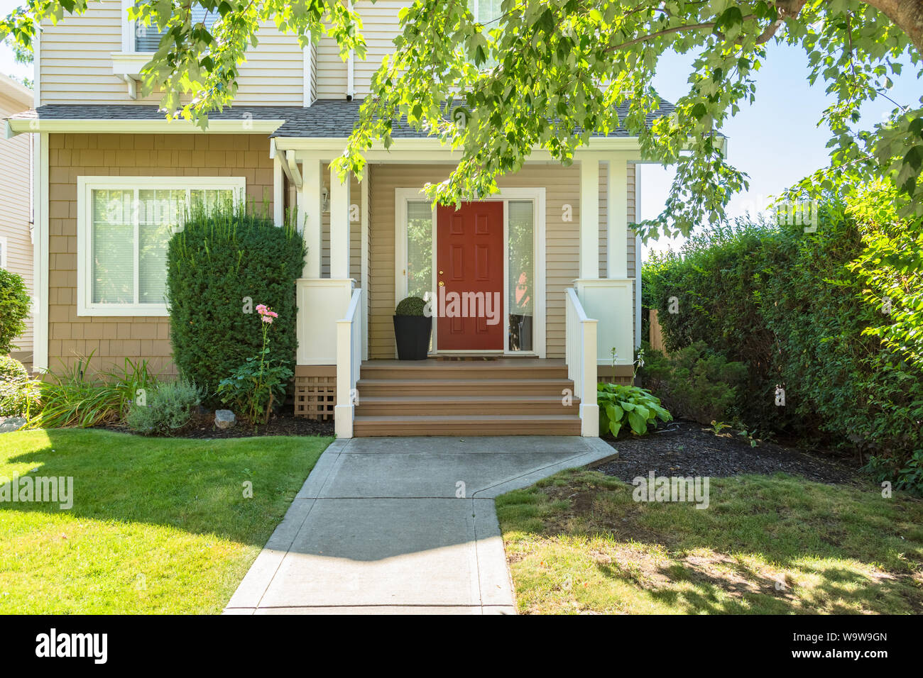 Door steps and concrete pathway leading to residential house main