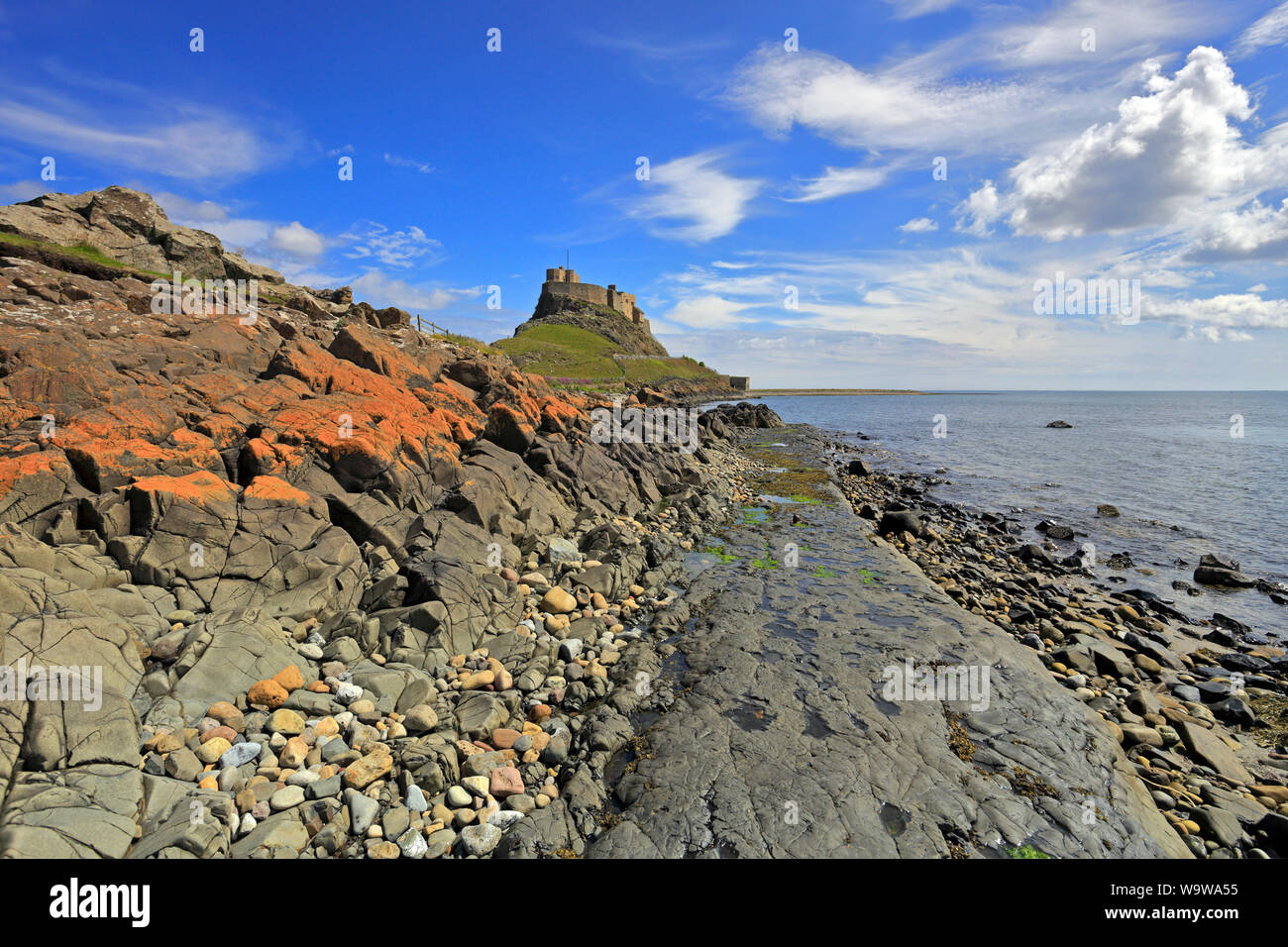 Lindisfarne Castle from the shoreline near the old jetties, Holy Island, Lindisfarne, Northumberland, England, UK. Stock Photo