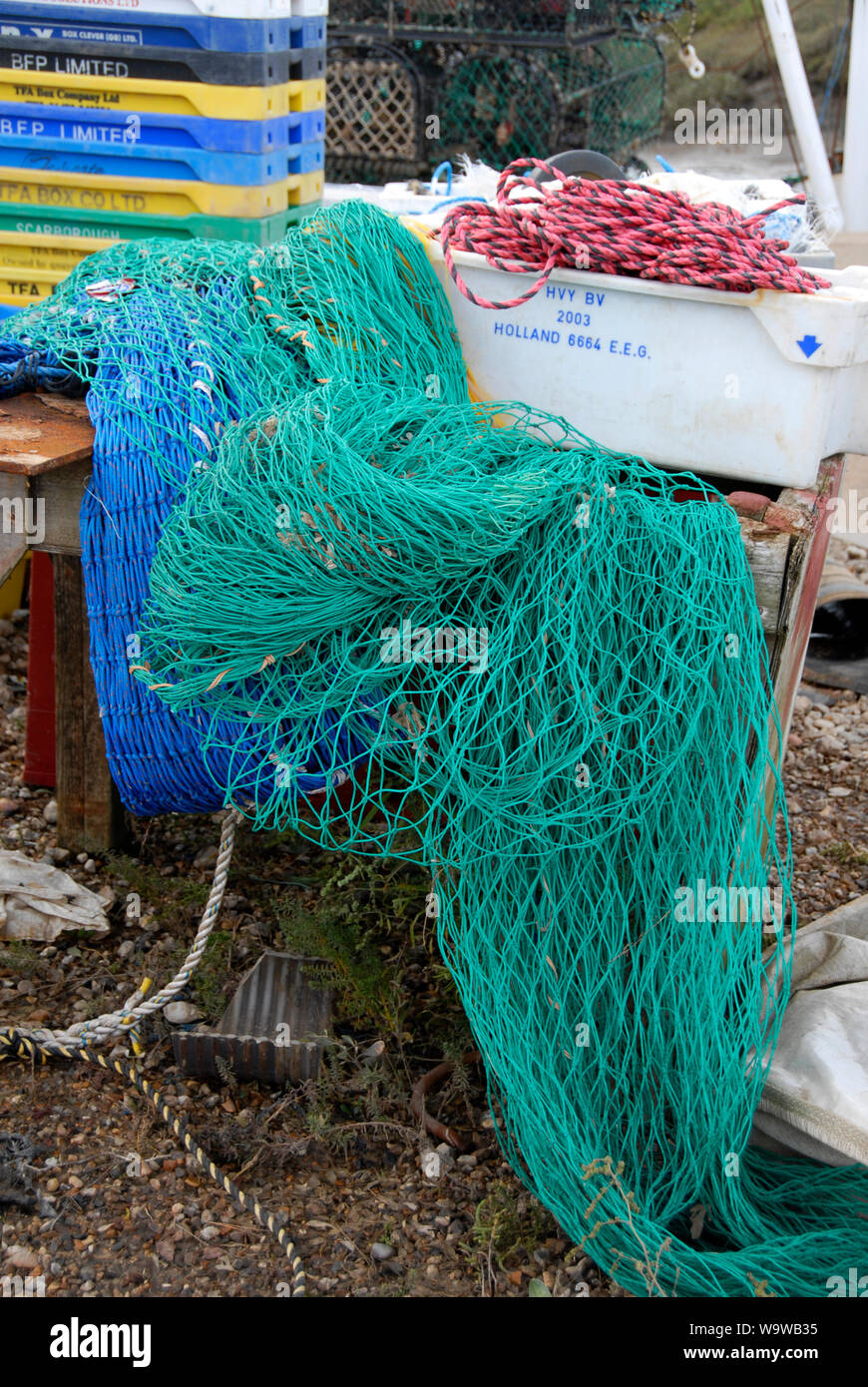 Colored nets and ropes on small fishing boat at Brancaster Staithe, on the north Norfolk coast, at low tide Stock Photo