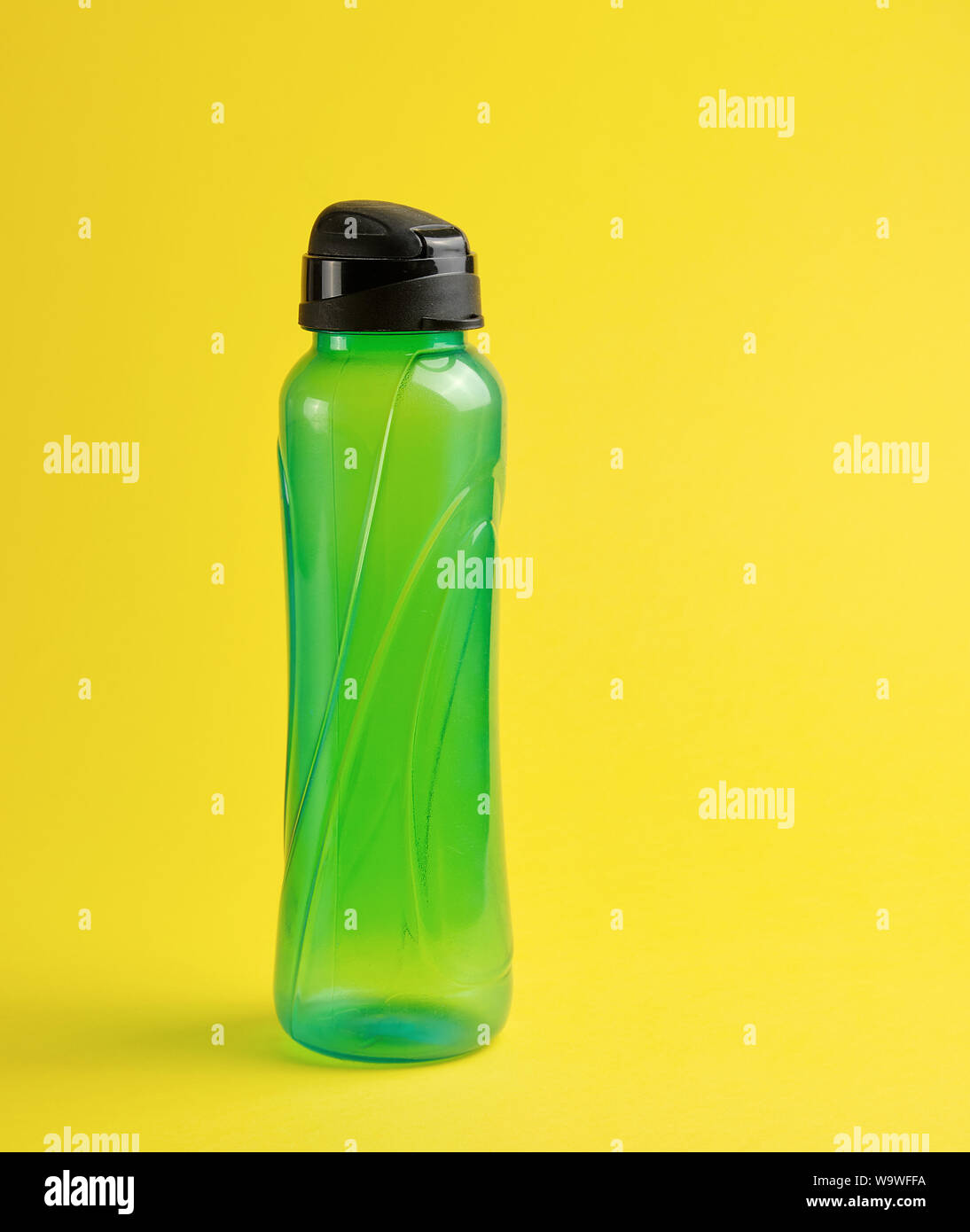 Download Closed Plastic Green Transparent Sports Bottle On A Yellow Background Close Up Stock Photo Alamy PSD Mockup Templates