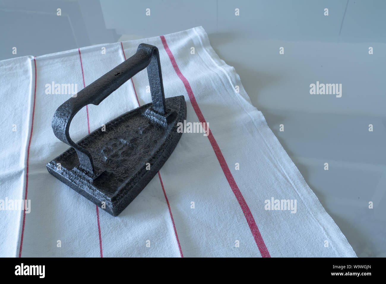 an vintage smoothing ironer object on a table Stock Photo