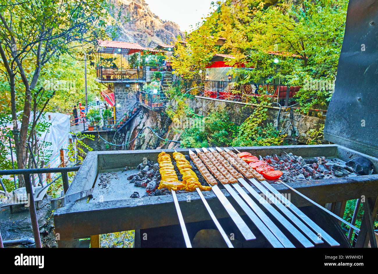 Darband restaurants offer traditional bbq (mangal) dishes, such as shishlik -pickled meat on skewers and kabob koobideh - kebab dish of lamb or beaf, Stock Photo