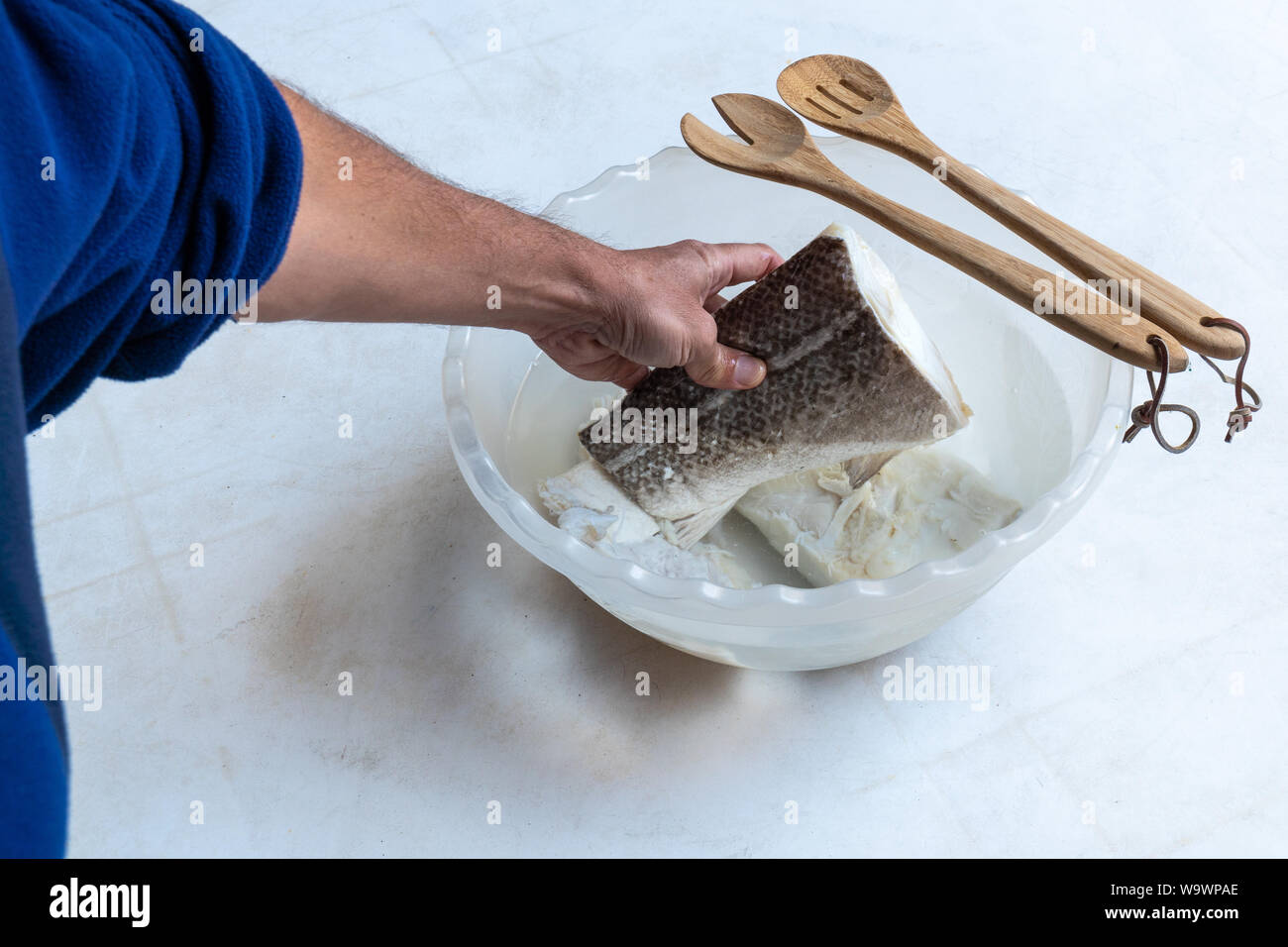 Salted and dried cod fish (Gadus morhua) in plastic bowl filled with