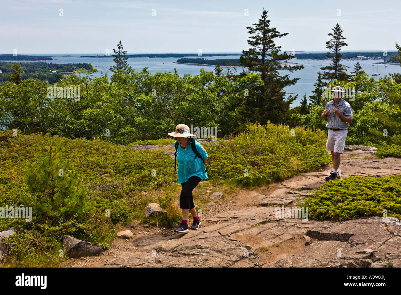 Christine and Pierre Kolisch hike up a hill on DESERT ISLAND - ACADIA NATIONAL PARK, MAINE Stock Photo