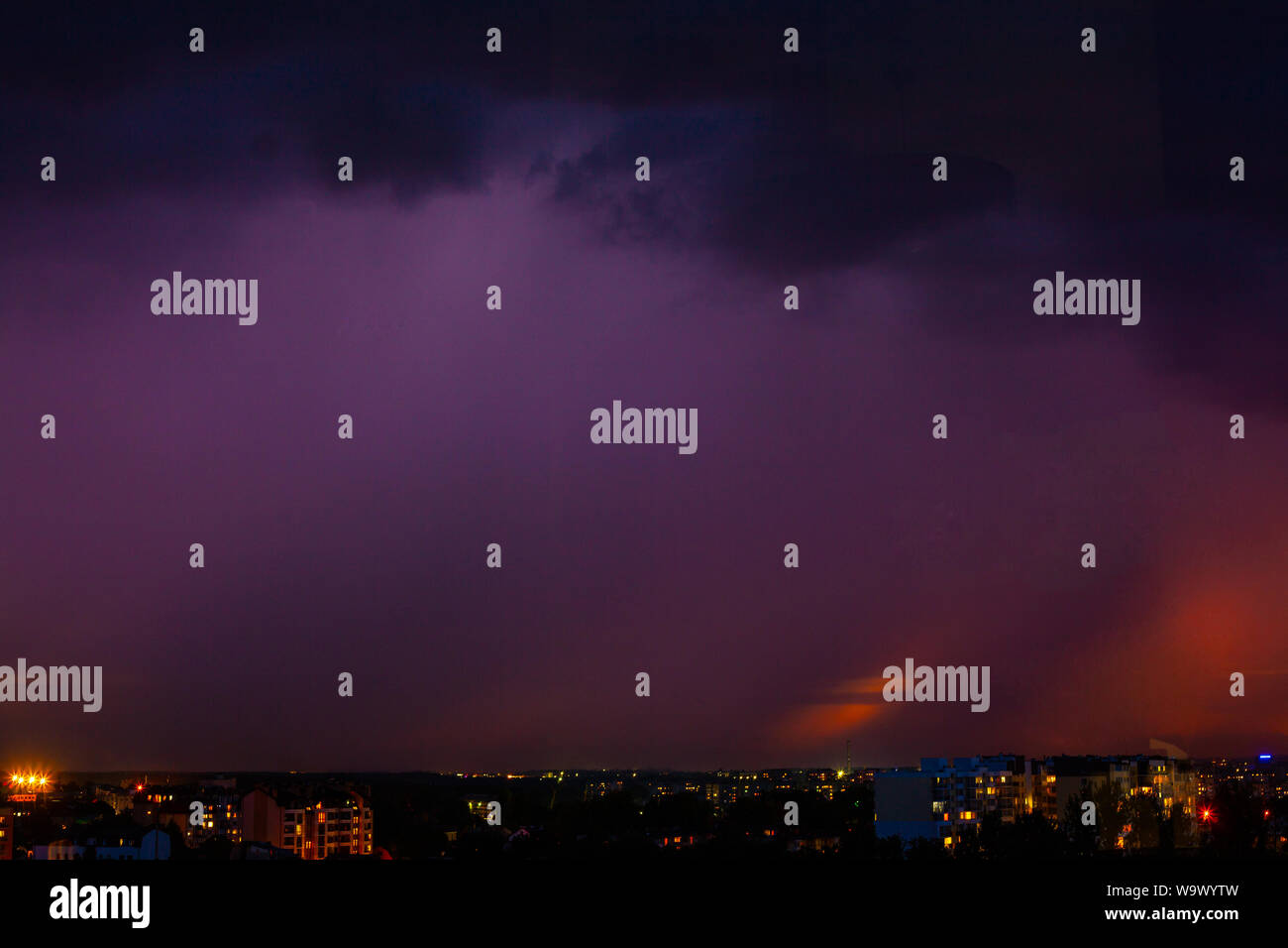 Lightning strikes storm over city purple light Stock Photo - Alamy