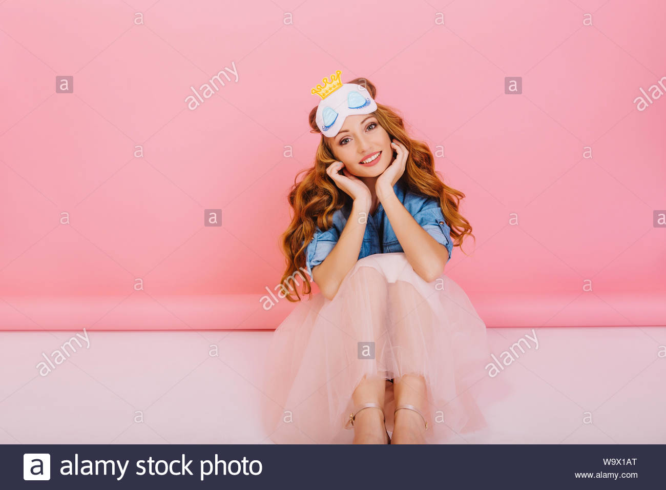 Lovely Lady With Long Curly Hair Sitting On The Floor In