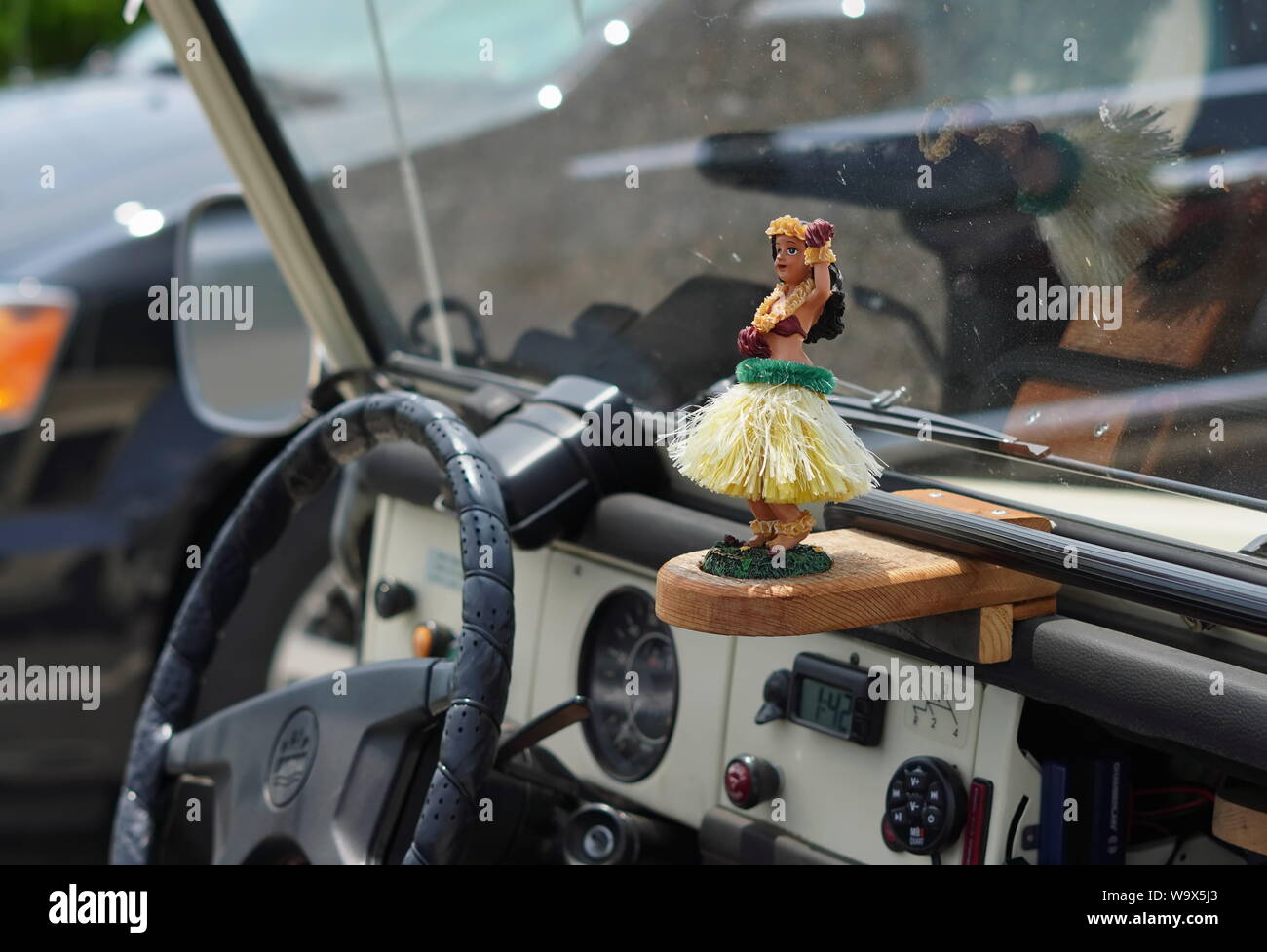 New London, CT / USA - June 22, 2019: Hula dancer ornament in a jeep wrangler with the top down Stock Photo
