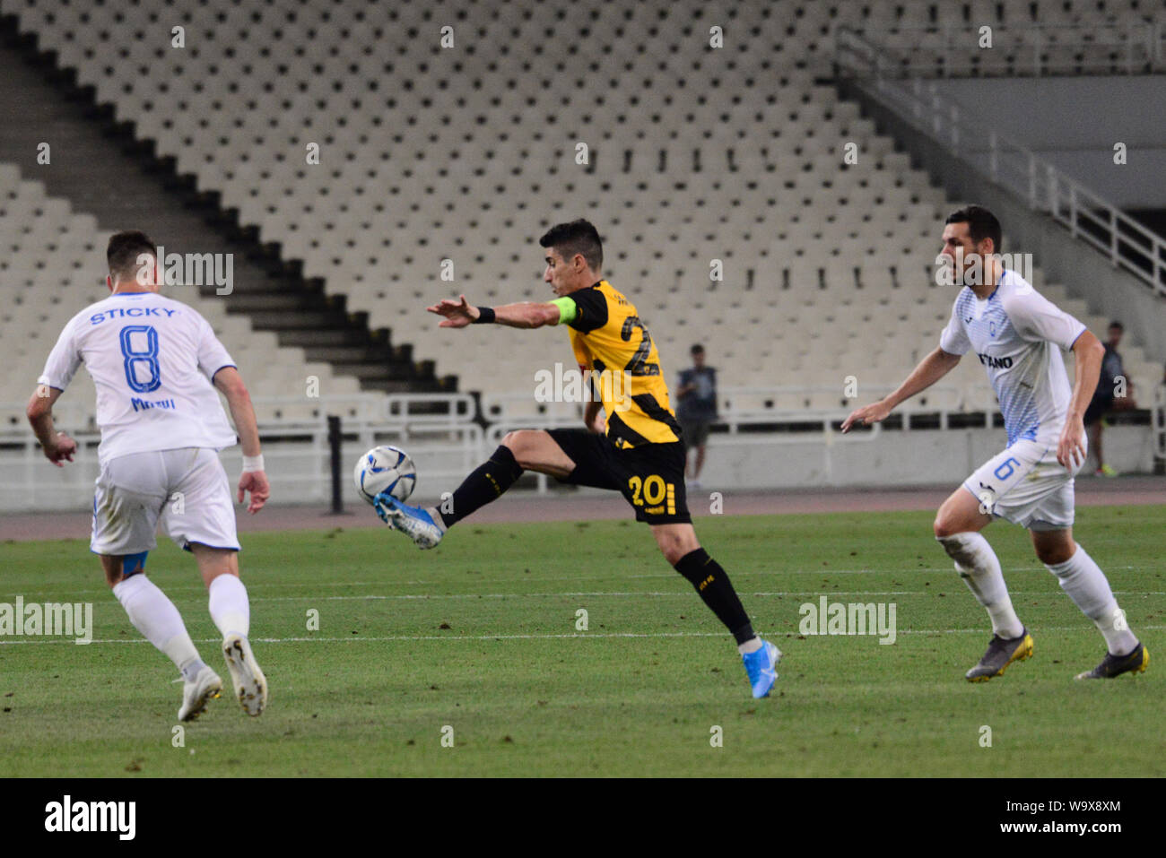 Athens, Greece. 15th Aug, 2019. Mantalos (no 20) of AEK controls the ball  under the pressure of two players of Craiova. (Photo by Dimitrios  Karvountzis/Pacific Press) Credit: Pacific Press Agency/Alamy Live News