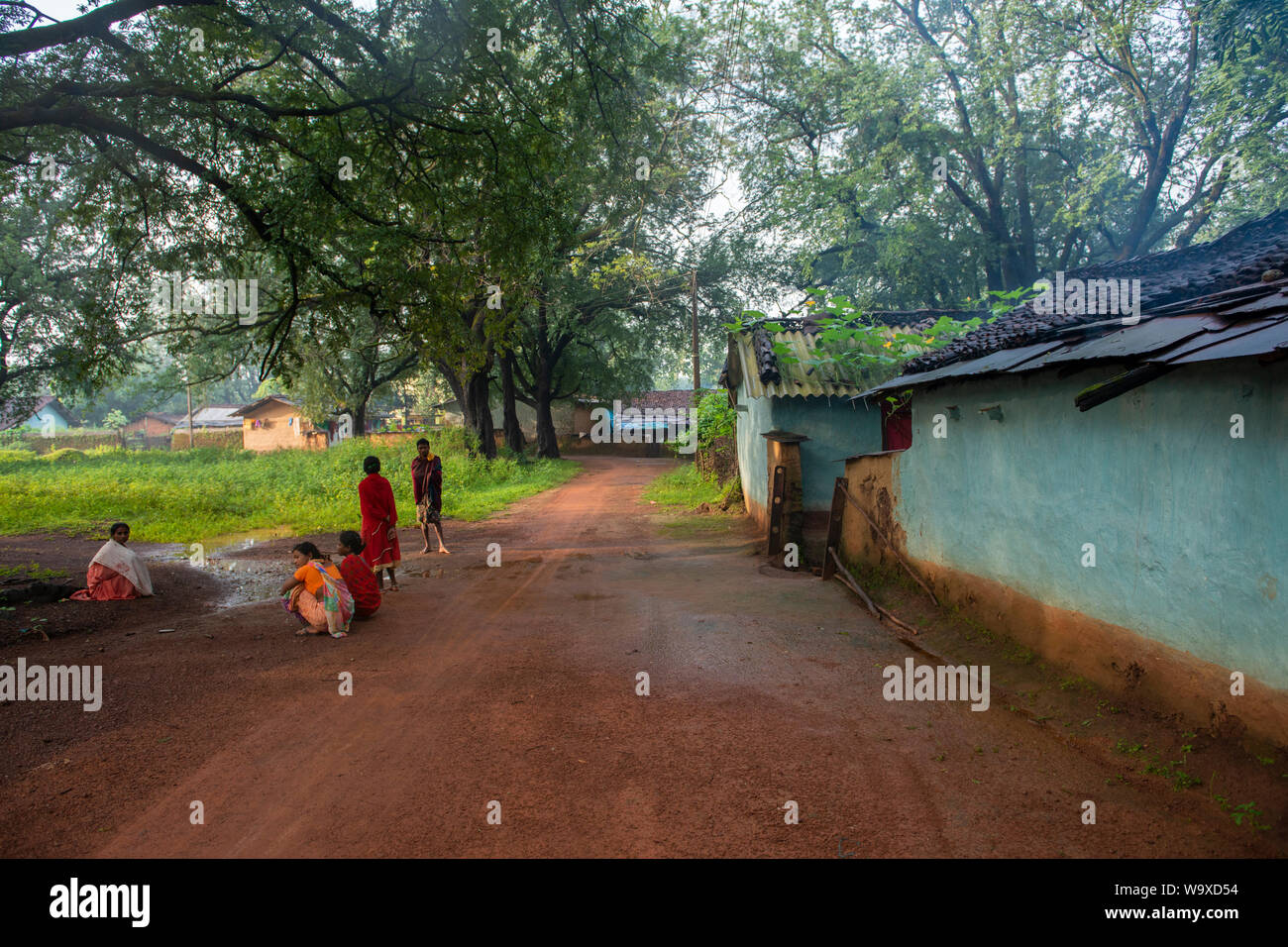 Villagers gathered outside house early morning  in a village near Jagdalpur,Chhattisgarh,India,Asia Stock Photo