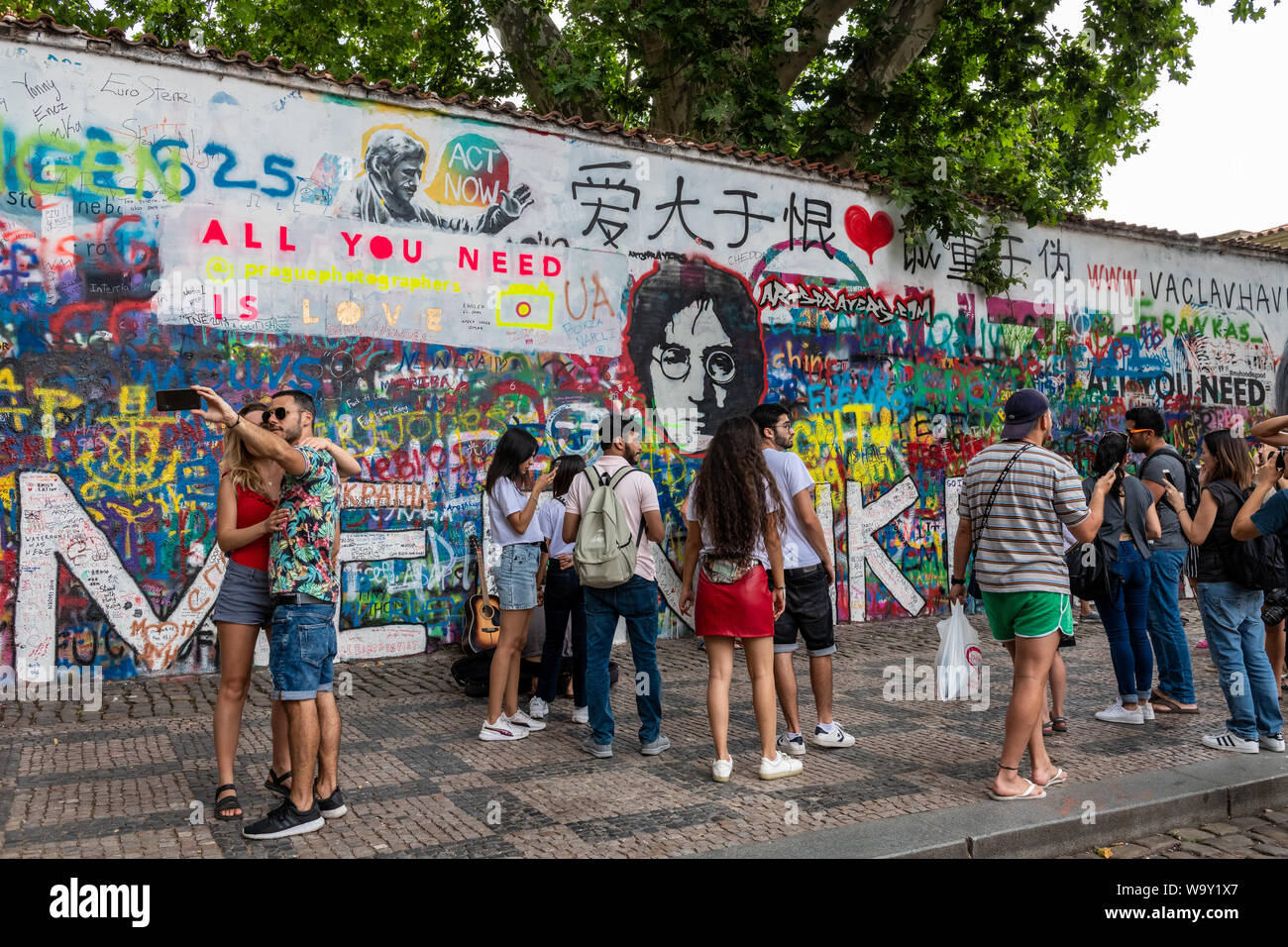 Crowds gather at the John Lennon Wall in Prague, Czech Republic Stock Photo