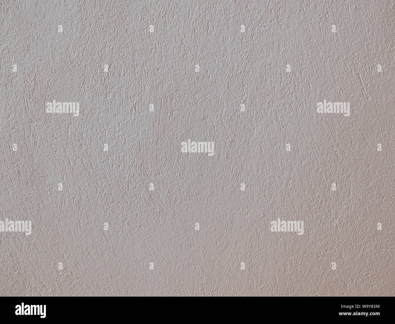 Textured grinded plaster in light beige. Background or texture seamless pattern. Stock Photo