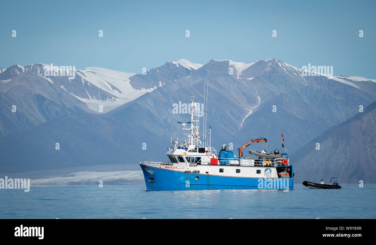 Pond Inlet, Canada. 15th Aug, 2019. A fishing boat is located off the coast of Pond Inlet, in the Canadian Arctic, in the sea. The small Inuit settlement with only 1,300 inhabitants will deal with the consequences of climate change, which is nowhere more visible than in the Arctic. Global warming here is two to three times stronger than in other regions of the world. Credit: Kay Nietfeld/dpa/Alamy Live News Stock Photo