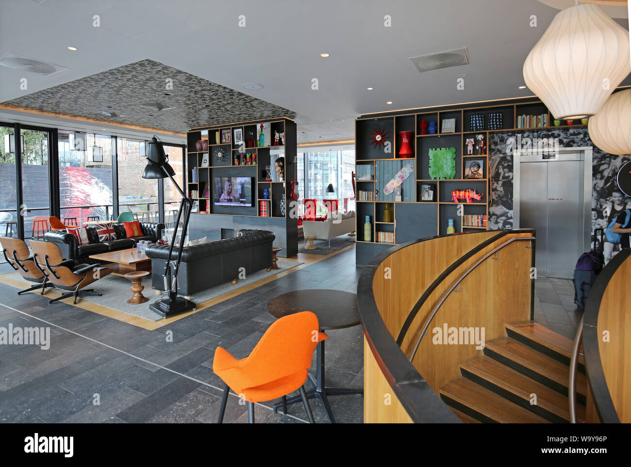 Entrance lobby and guests lounge in London's Shoreditch Citizen M Hotel, UK. One of the many trendy, new hotels in this fashionable part of the city. Stock Photo