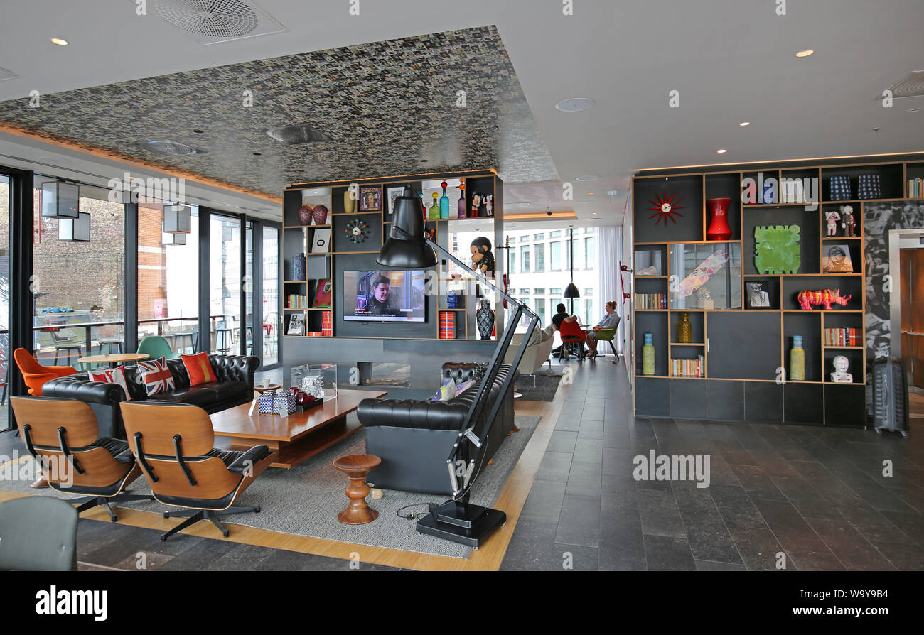 Entrance lobby and guests lounge in London's Shoreditch Citizen M Hotel, UK. One of the many trendy, new hotels in this fashionable part of the city. Stock Photo