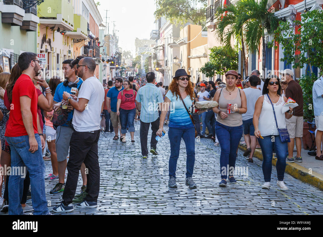 Tourists and locals explore out in streets with anticipation for the start of  San Sebastian Street Festival in Old San Juan, San Juan, Puerto Rico. Stock Photo