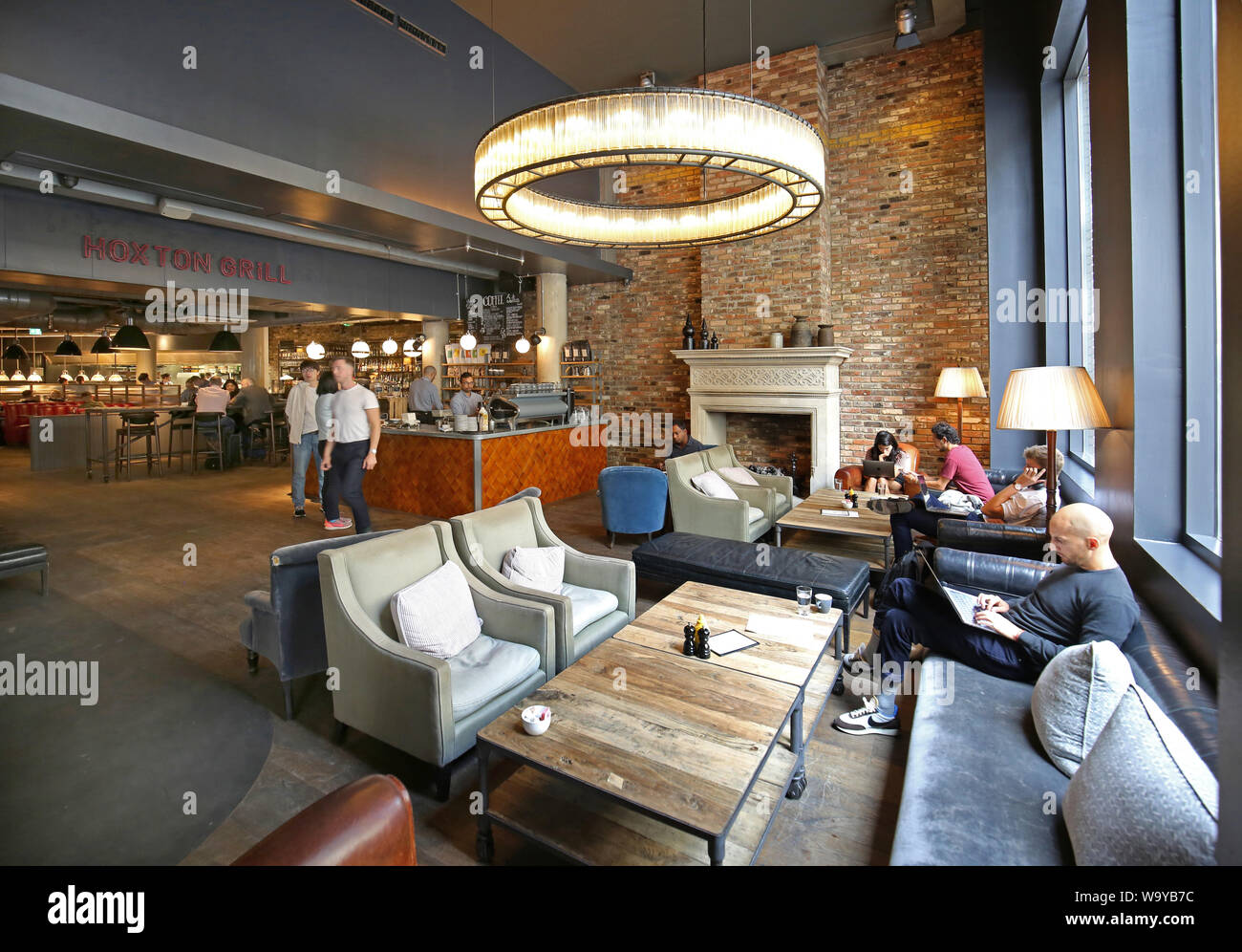 Customers relax in the entrance lobby, bar and restaurant area at London's  trendy Hoxton Hotel in Shoreditch, UK Stock Photo - Alamy