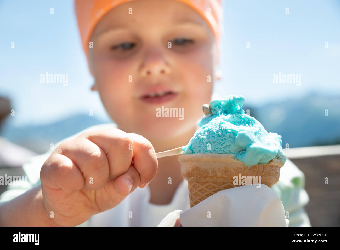 Little Girl Eating Ice Cream In Summer On A Hot Day Stock Photo