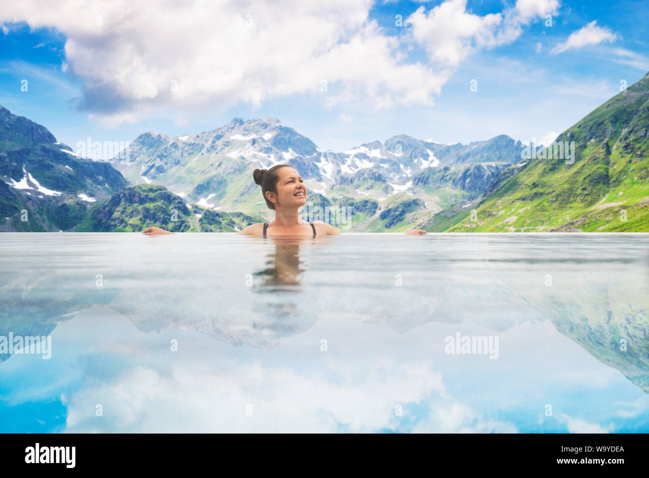Photo Of Woman In Infinity Pool In Mountains Stock Photo