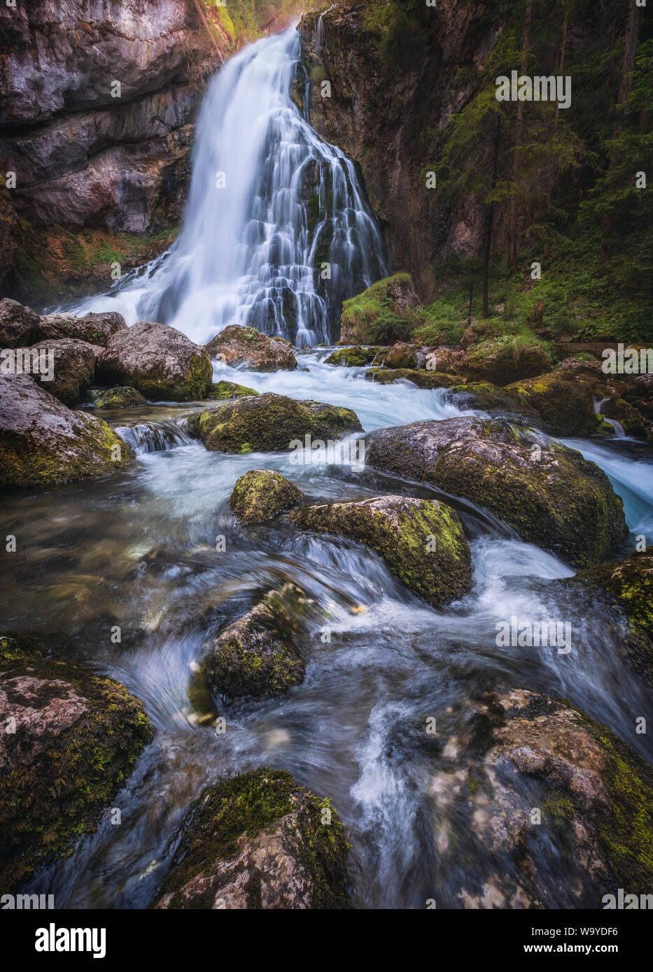 Scenic waterfall landscape with green moos stones and flowing river at beautiful summer day in Gollinger, Austria. Stock Photo
