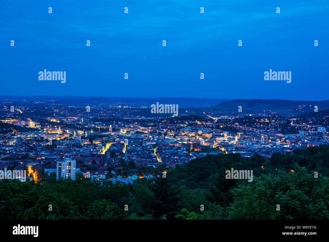 Germany, Stuttgart state capital houses of big city from hilltop of mount rubble in magical twilight mood by night Stock Photo
