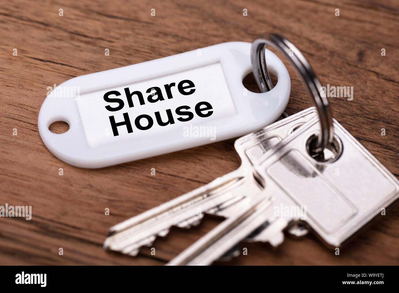 Close-up Of Share House Keys On Wooden Desk Stock Photo