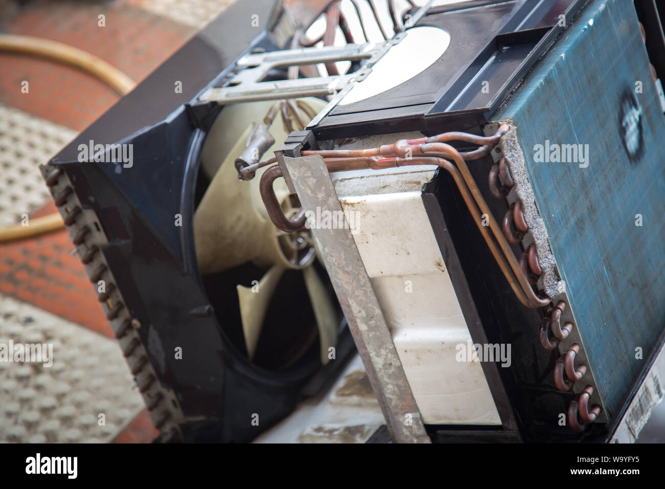 Worker cleaning window air conditioner by water for clean a dust on it