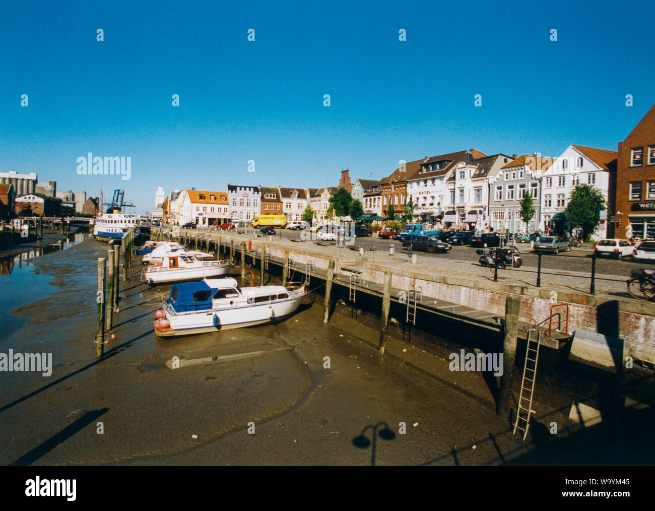 HUSUM GERMANY the harbor with boats at the bottom of the ebb Stock Photo