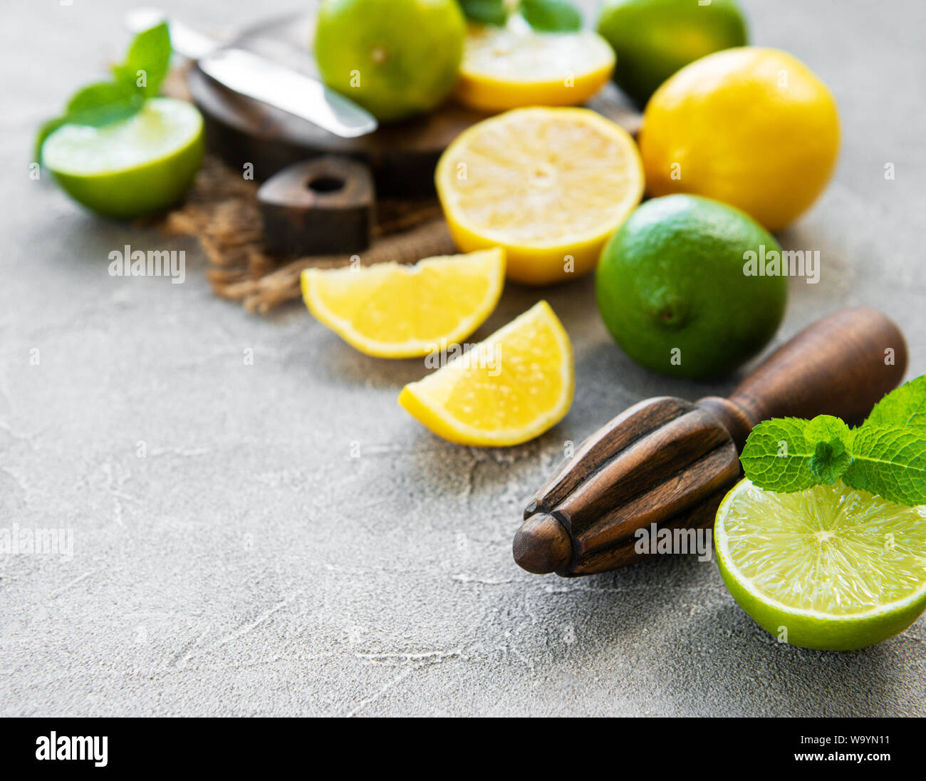 Lemons and limes on a concrete background Stock Photo Alamy