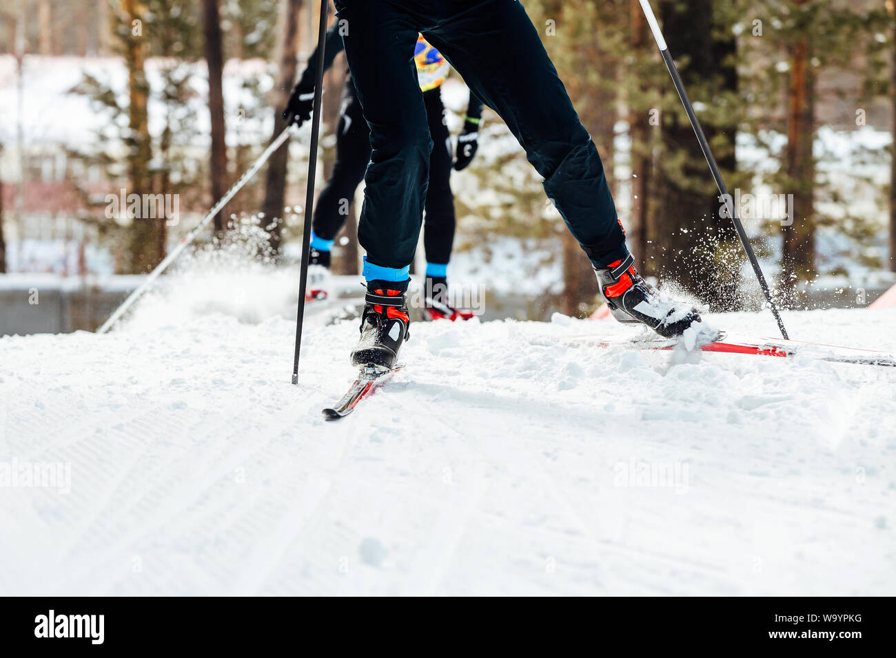 competition cross-country skiing two skiers athletes uphill Stock Photo