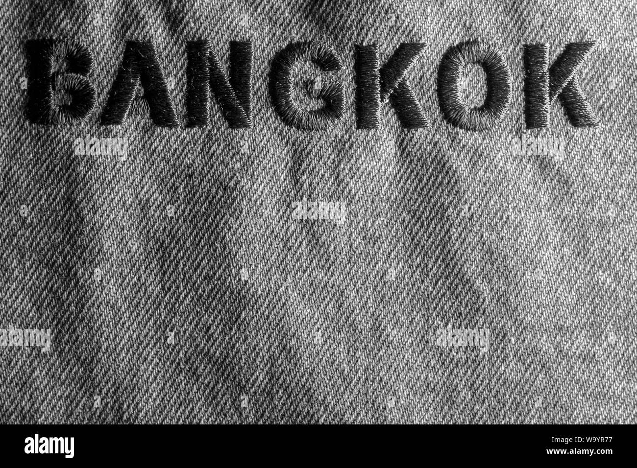 Background blue jeans labeled Bangkok embroidery on jeans. Stock Photo