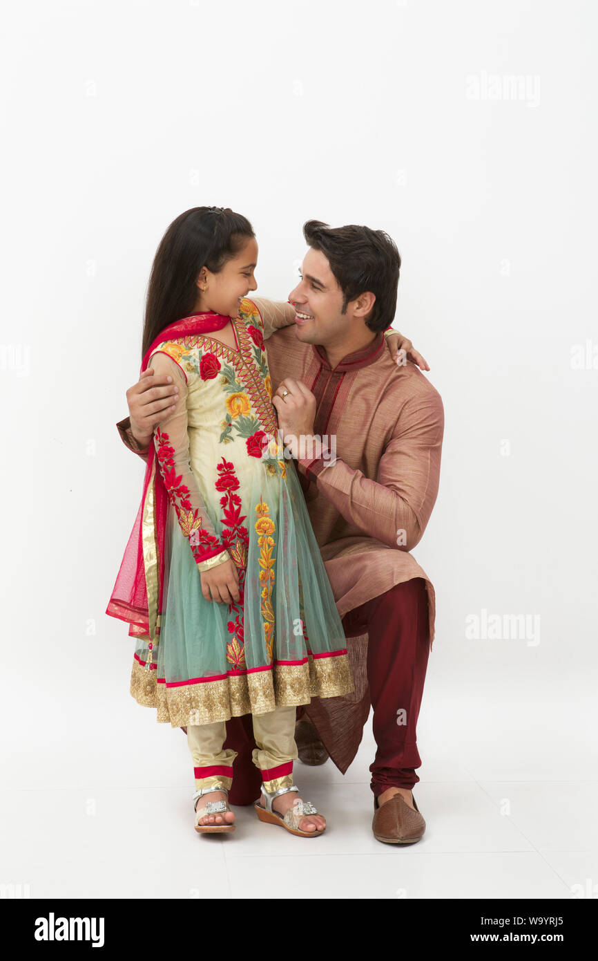 Man with his daughter looking at each other and smiling Stock Photo