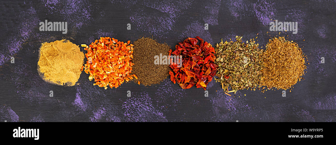 Different spices on dark background. Top view. Banner. Stock Photo