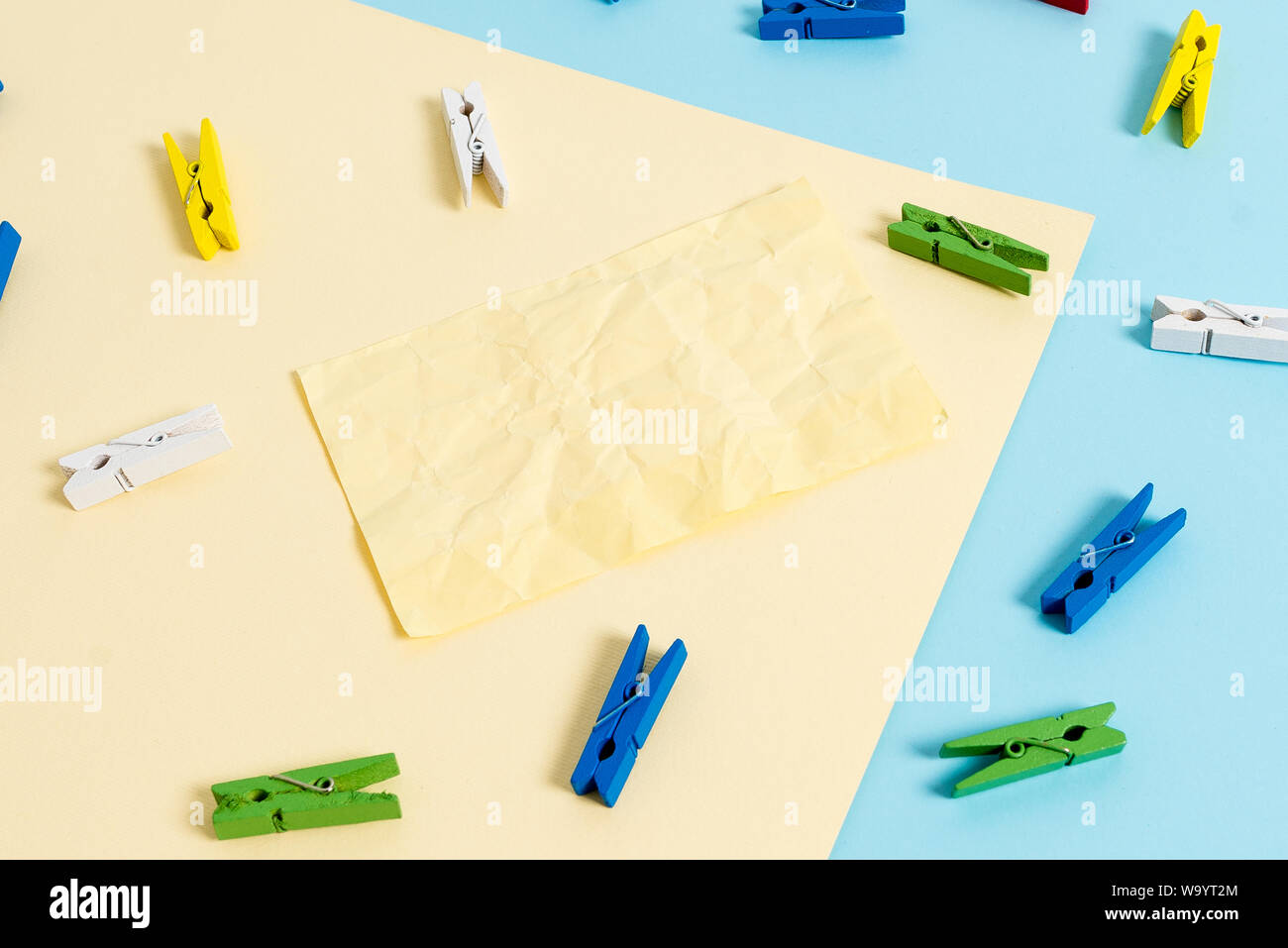Colored clothespin paper empty reminder yellow blue floor background