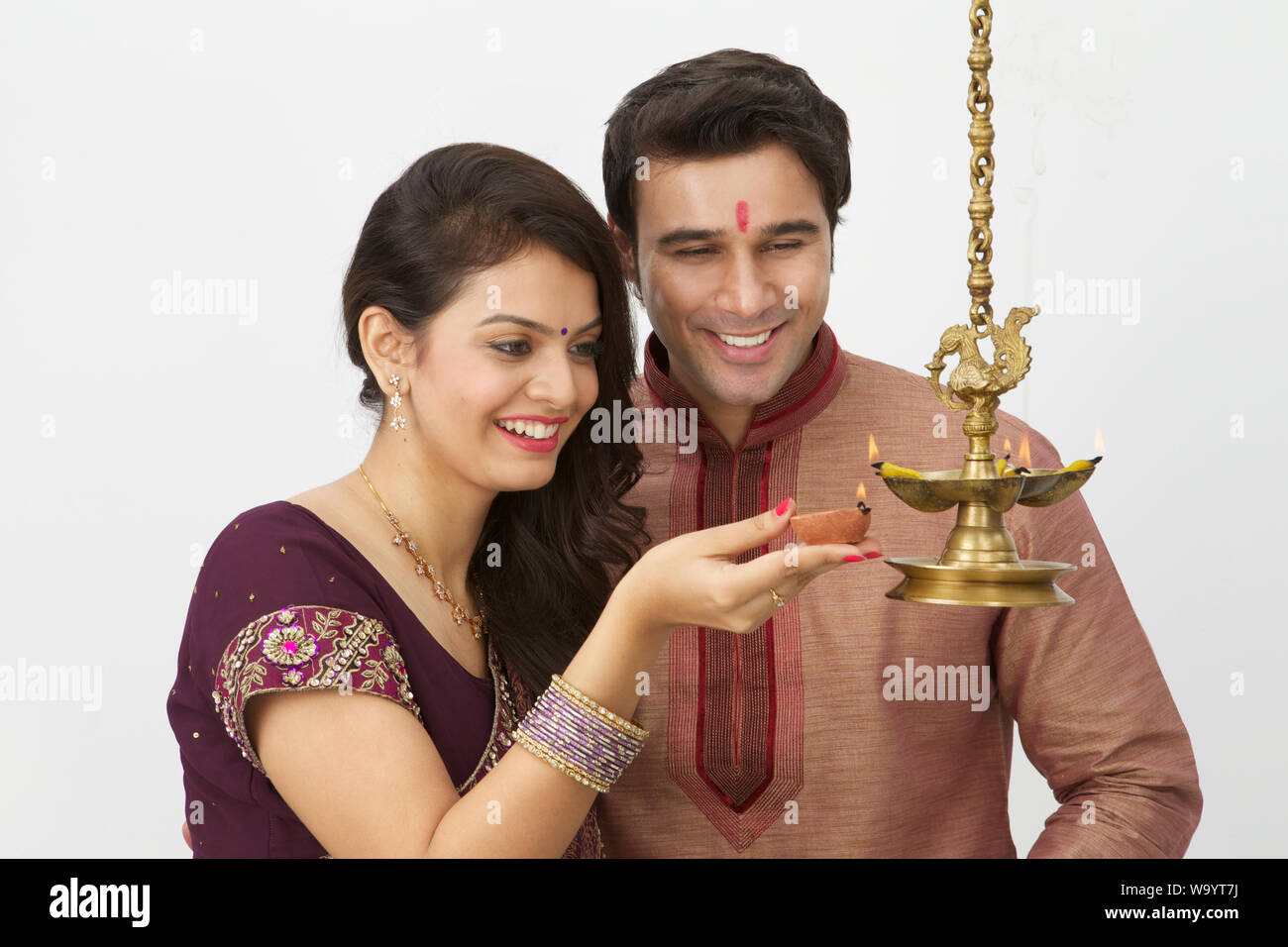 Young couple burning oil lamp Stock Photo
