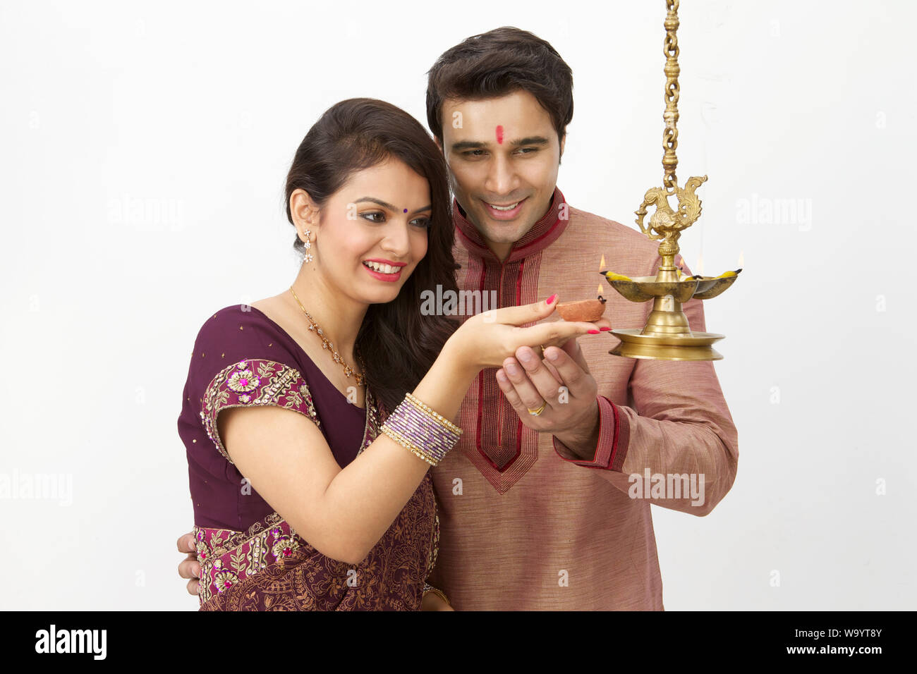 Young couple burning oil lamp Stock Photo