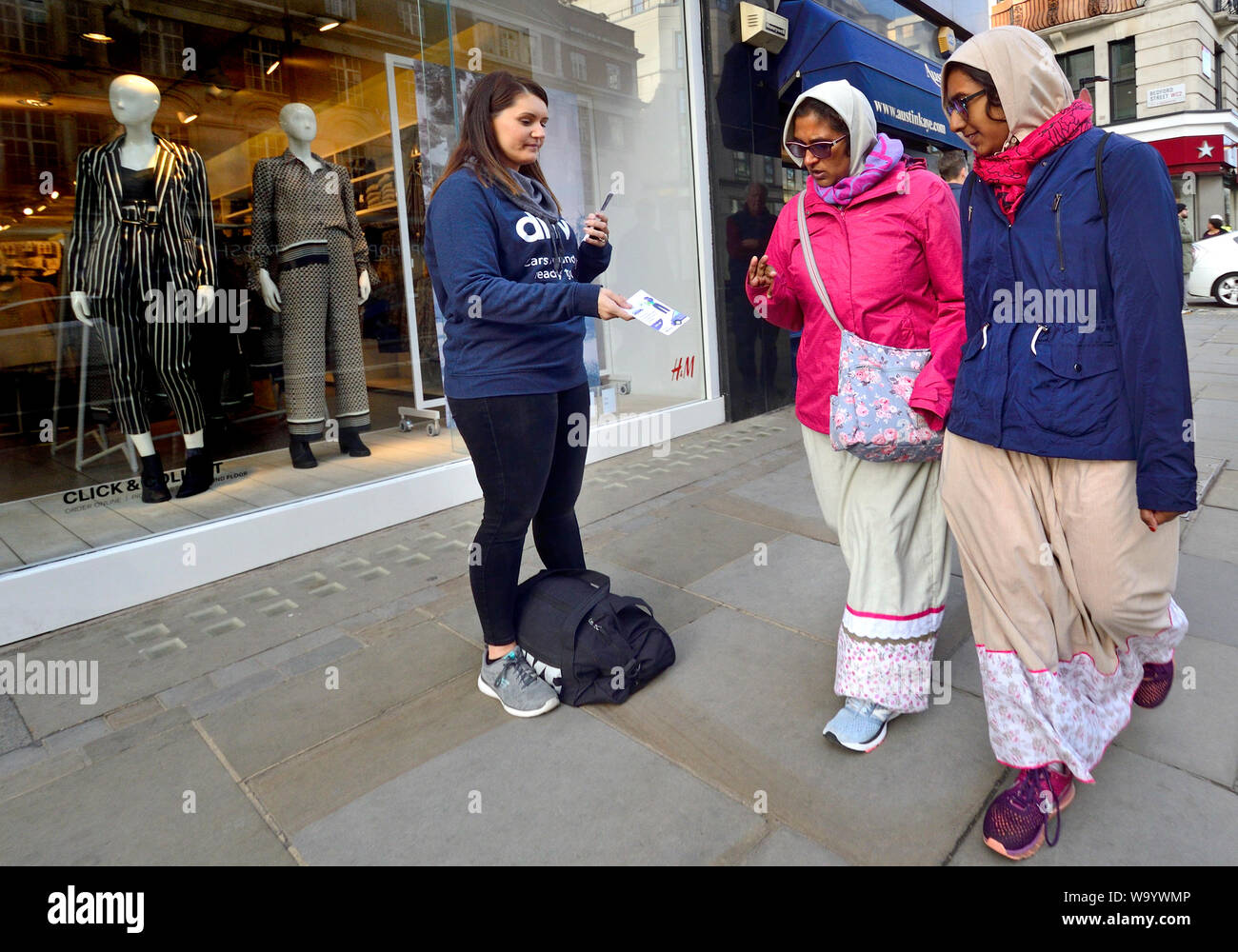 London, England, UK. Woman handing out leaflets in Oxford Street Stock Photo