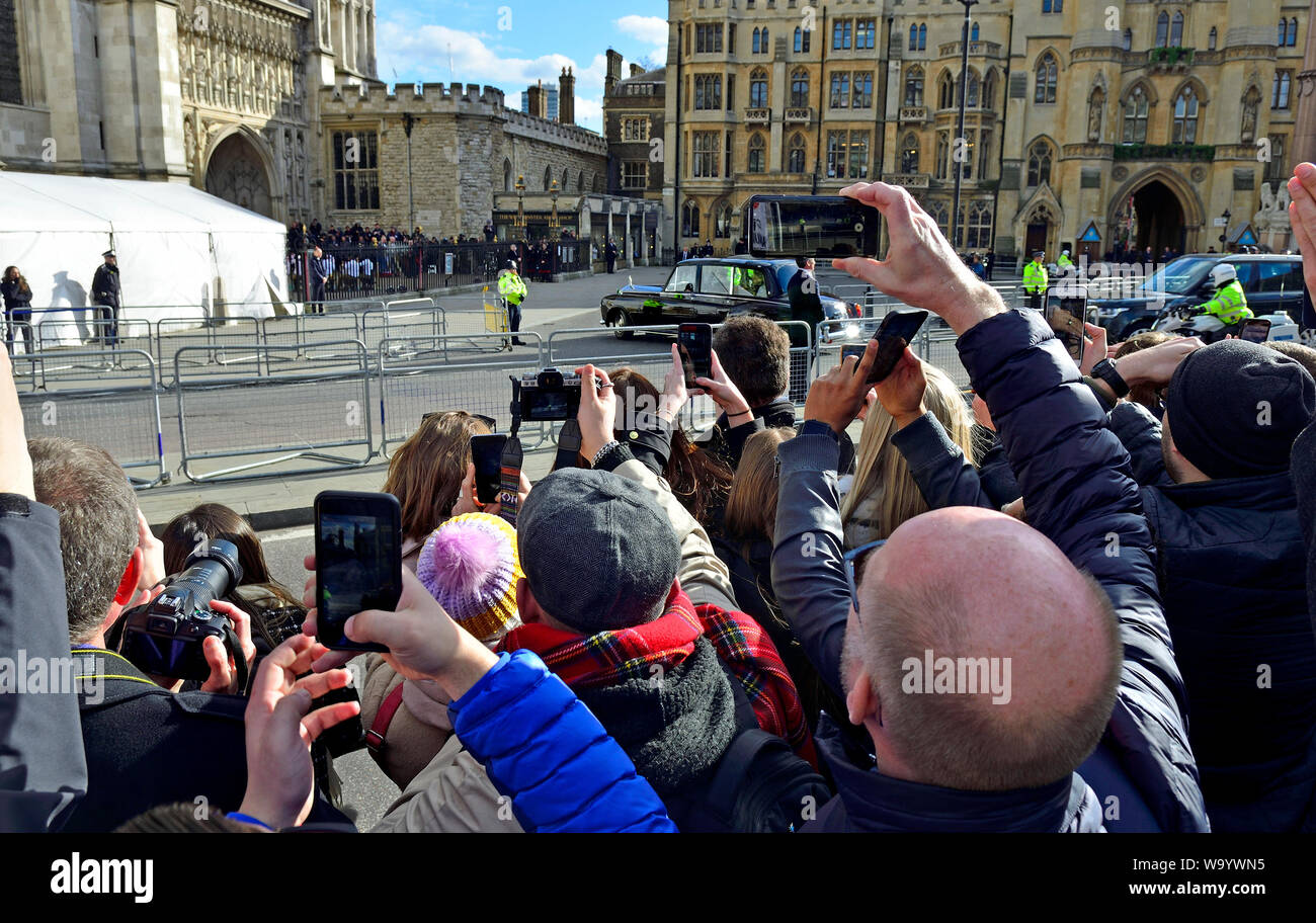 London, England, UK. Crowd outside Westminster Abbey filming the arriveal of The Queen with their mobile phones Stock Photo