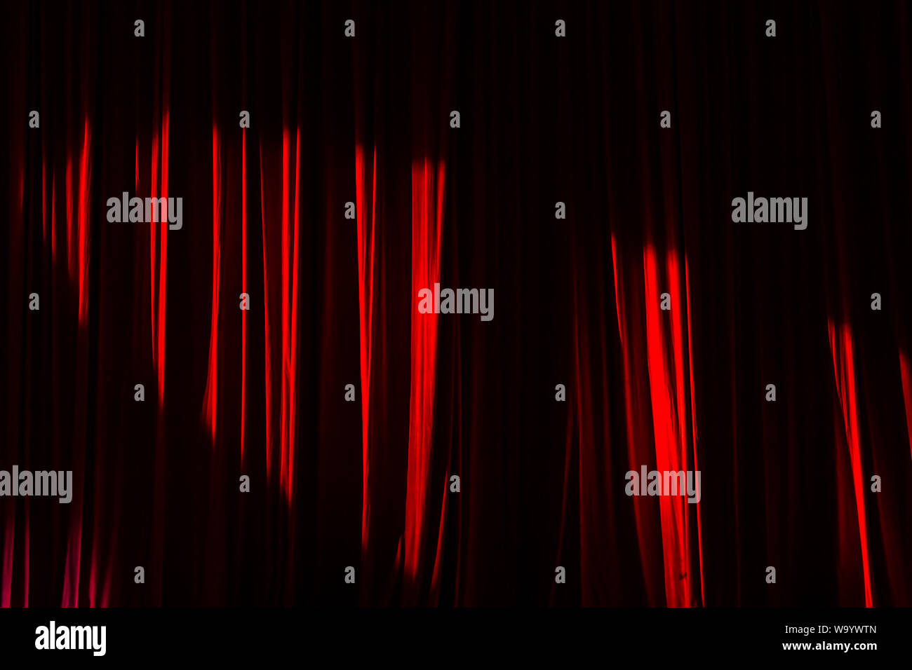 Red curtain and lights in the theater before the show. Stock Photo