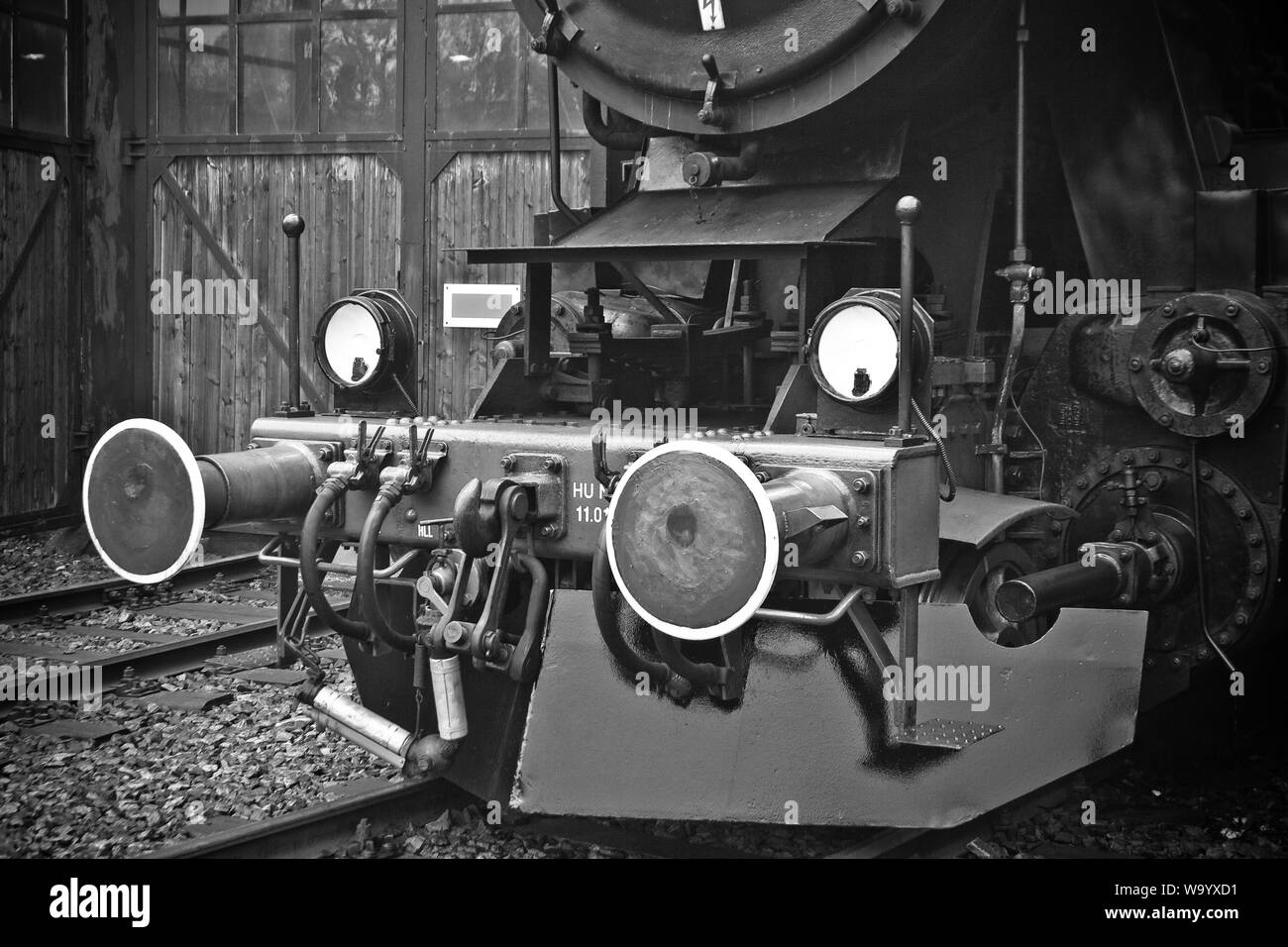 Old retro steam locomotive in a depot Stock Photo