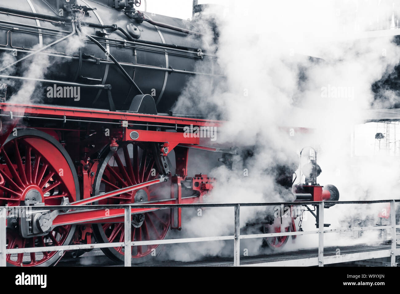 Old retro steam locomotive in a depot Stock Photo