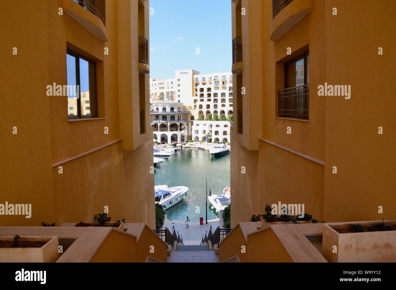 Portomaso Marina glimpsed between buildings st julians malta Stock Photo